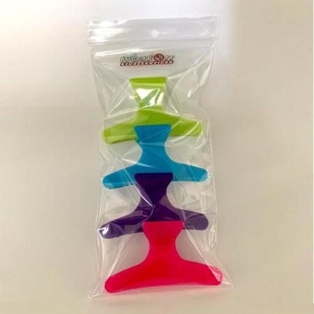 Product photo: 4 colourful plastic hair clips in a branded Bugger Off Lice Services bag